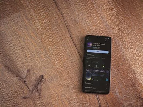 Stellarium - Star Map app play store page on smartphone on wooden background Stock Photos
