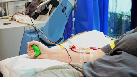 Stem Cell Donation with Donor Squeezing Ball During Apheresis Procedure Stock Footage 316221897