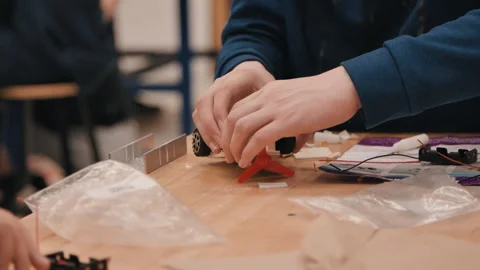 STEM class kids working on robot cars close up hands Stock Footage 283607279