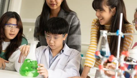 STEM education concept. Asian children in laboratory research an experiment.. Stock Photos