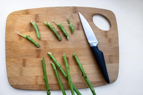 Stems of flowers, cut with a sharp knife, lying on the board. Trimming plucke Stock Photos