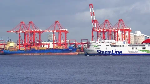 The Stena Ferry passes the container handling cranes of the Port of Liverpool Stock Footage 143256623