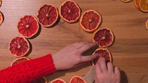 Step 1 Woman using hot glue Handmade Christmas wreath from dried orange Stock Footage 280963046