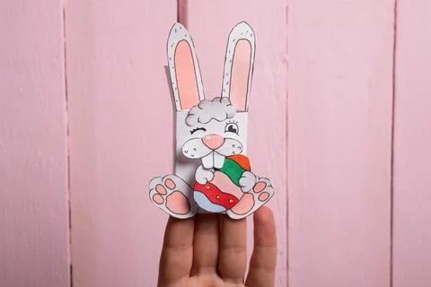 Step 14. DIY Children's Easter craft bunny with an egg. Easter craft paper st Stock Photos