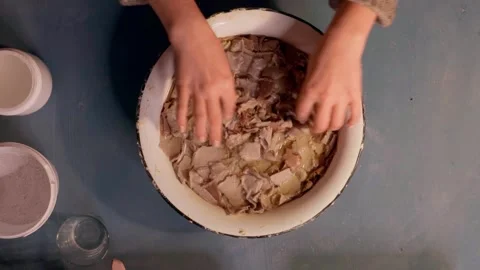 Step 2 soaking torn egg cartons in water for papier mache pulp preparation top v Stock Footage 330681437
