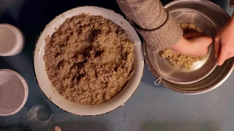 Step 3 squeezing paper pulp by hand for papier mache mixture Stock Footage 330682623