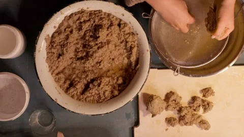 Step 3 squeezing paper pulp by hand for papier mache mixture Stock Footage 330682919