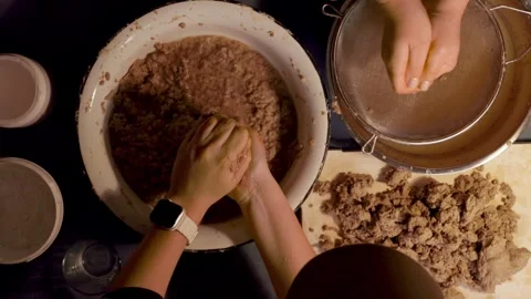 Step 3 squeezing paper pulp by hand for papier mache mixture Stock Footage 330683103