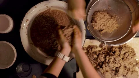 Step 3 squeezing paper pulp by hand for papier mache mixture Stock Footage 330683462