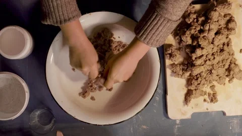 Step 3 squeezing paper pulp by hand for papier mache mixture Stock Footage 330683897