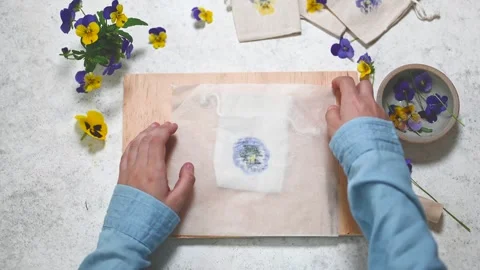 Step 4. Child peels off the top layer of fabric to reveal the print and pulls Stock Footage 280359698
