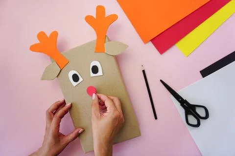 Step 4. Making a gift package in the form of a Christmas deer Stock Photos