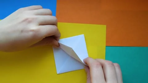 Step 7. female hands make paper boat. Step-by-step instructions origami ship. Stock Footage 130525329