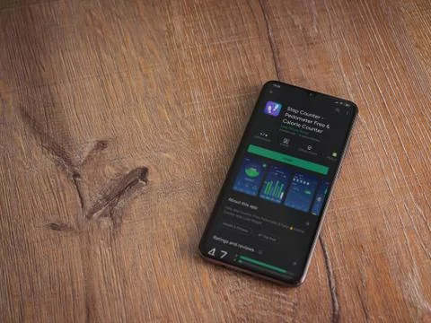 Step Counter app play store page on the display of a black mobile smartphone  Stock Photos