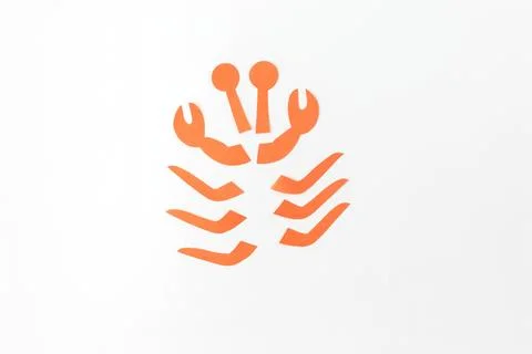 Step in creative process, an arrangement of orange paper cutouts on a white.. Stock Photos