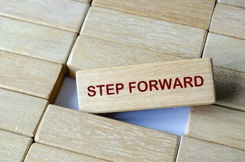 STEP FORWARD text on wooden blocks illustrating proactive action and respon.. Stock Photos