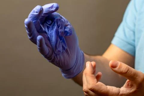 Step of hand throwing away blue disposable gloves medical, Isolated on white  Stock Photos