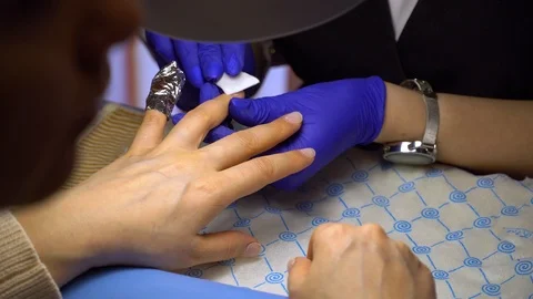 Step of manicure process: nail gel polish removal using foil pieces. Video stock 103935955