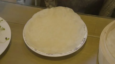 Step-by-Step Assembly and Folding of Chinese Pancake Wrap at Table in Beijing Stock Footage 345789945