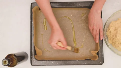 Step by step baking pizza recipe. Grease the tray with olive oil Stock Footage 148010560