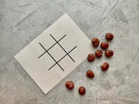 Step by step, children's creativity, game TIC TAC toe of chestnuts. Stock Photos