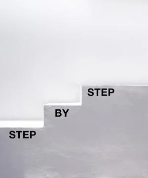 Step by step concept. The words, step by step, black color text on white cons 스톡 사진