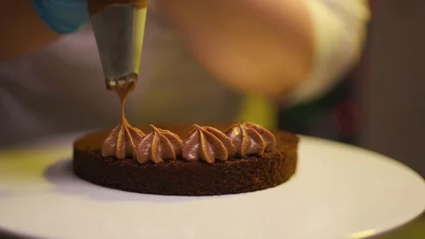 Step by step. The cook collects a chocolate cake with multi-colored Stock Footage 119856909