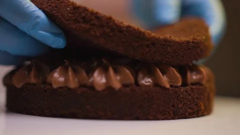 Step by step. The cook collects a chocolate cake with multi-colored Stock Footage 119856928