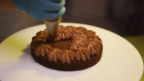 Step by step. The cook collects a chocolate cake with multi-colored Stock Footage 119856929