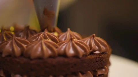 Step by step. The cook collects a chocolate cake with multi-colored Stock Footage 119856942