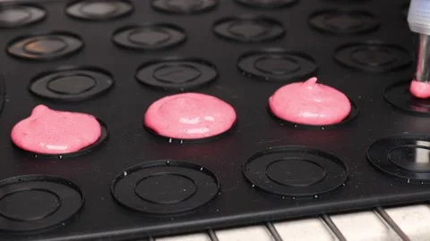 Step by step cooking macarons dessert. a girl pours dough Stock Footage 238397052