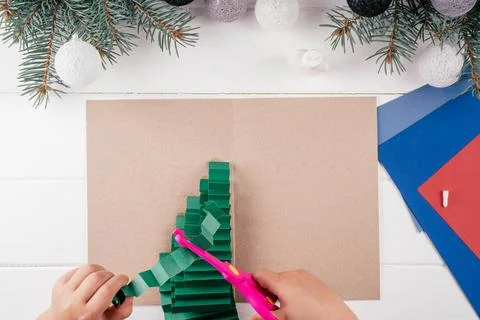Step-by-step Greeting card 3D Christmas tree tutorial. Step 14: Cut some fold Stock Photos