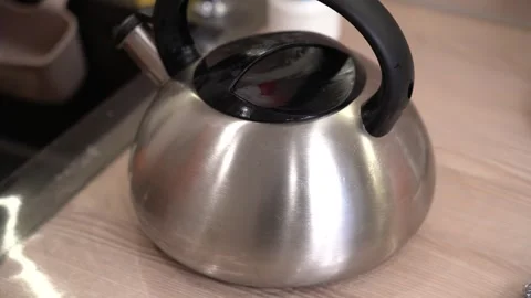 A Step-by-Step Guide to Cleaning and Maintaining a Stainless Steel Kettle for Stock Footage 321051144