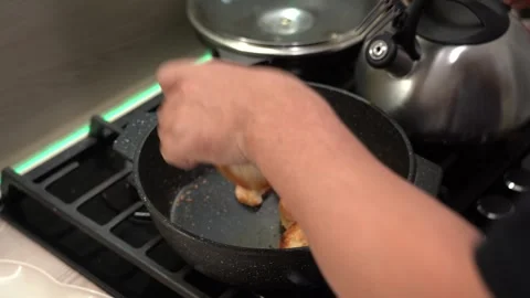 A Step-by-Step Guide to Perfectly Toasting Bread: Sizzling Slices in a Hot Pan Stock Footage 321051175
