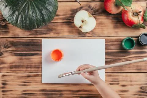 Step-by-step Halloween childrens tutorial pumpkin apple prints. Step 4: Child Stock Photos