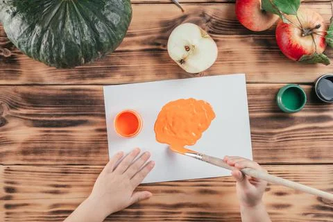 Step-by-step Halloween childrens tutorial pumpkin apple prints. Step 5: Child Stock Photos