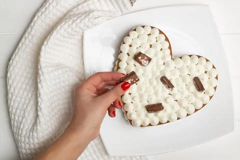 Step-by-step heart-shaped cake recipe instructions. Step 12: Decorate with ch Stock Photos