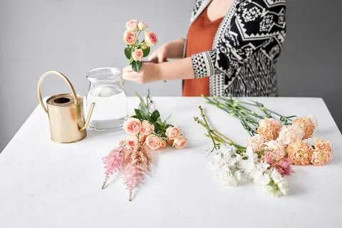 Step by step installation of flowers in a vase. Flowers bunch, set for home Stock Photos