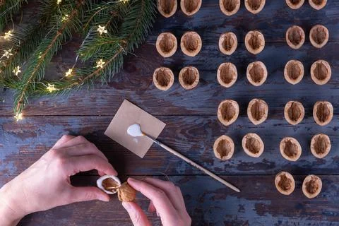 Step-by-step instructions: DIY golden nut tree toy. Step 8: glue the two halv Stock Photos