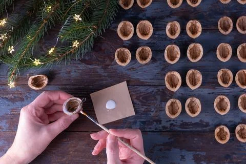 Step-by-step instructions: DIY golden walnut tree toy with a metal holder. St Stock Photos