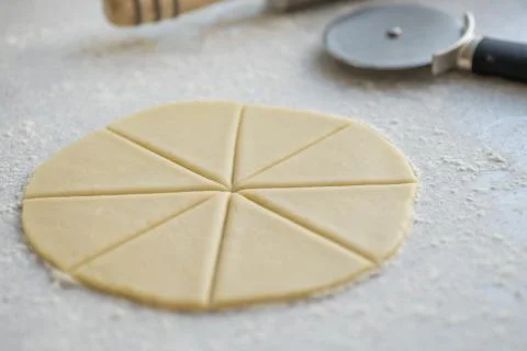 Step-by-step instructions for making bagel cookies, cut a circle of dough into 6 Stock Photos