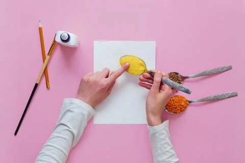 Step by step instructions for making a kids crafts. Step 3 - pour cereal onto Stock Photos