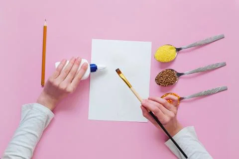Step by step instructions for making a kids crafts. Step 2 - applying glue to Stock Photos