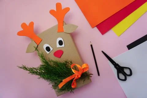 Step-by-step instructions for making packaging for a gift in the form of a deer Stock Photos