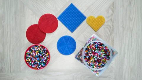 Step-by-step instructions for thermo mosaic: step 1.Set of forms,container,beads Stock Photos