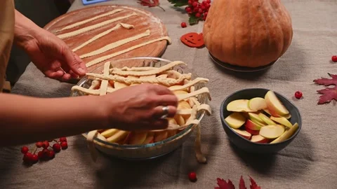 Step-by-step making a crusty lattice pattern from striped pastry dough, on top Stock Footage 216957285