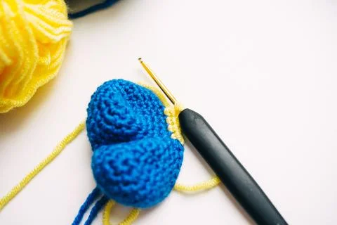Step-by-step master class on crocheting a two-color heart. step 7. finish Stock Photos