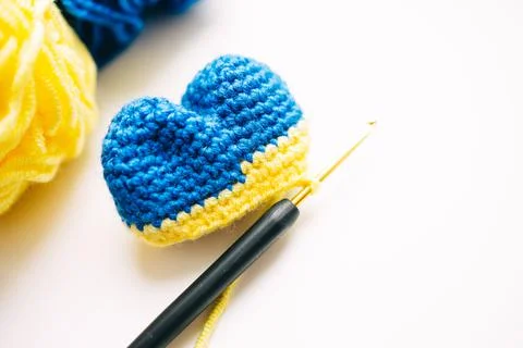 Step-by-step master class on crocheting a two-color heart. step 7. finish Stock Photos