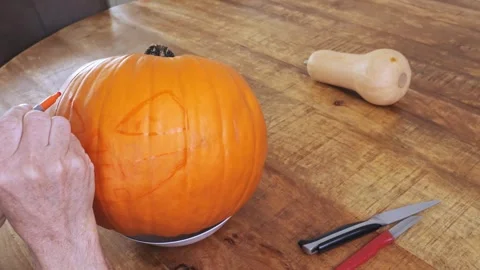 Step-by-step process of carving pumpkin into jack-o’-lantern for Halloween Stock Footage 317225793
