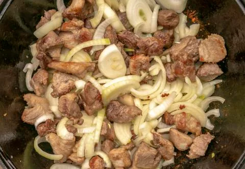 Step-by-step process of cooking pilaf in a cast iron cauldron Stock Photos